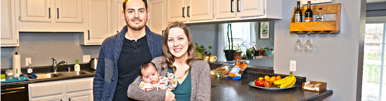 Couple with baby in new kitchen