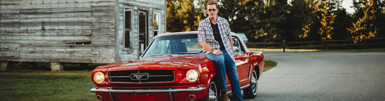 Guy leaning on mustang