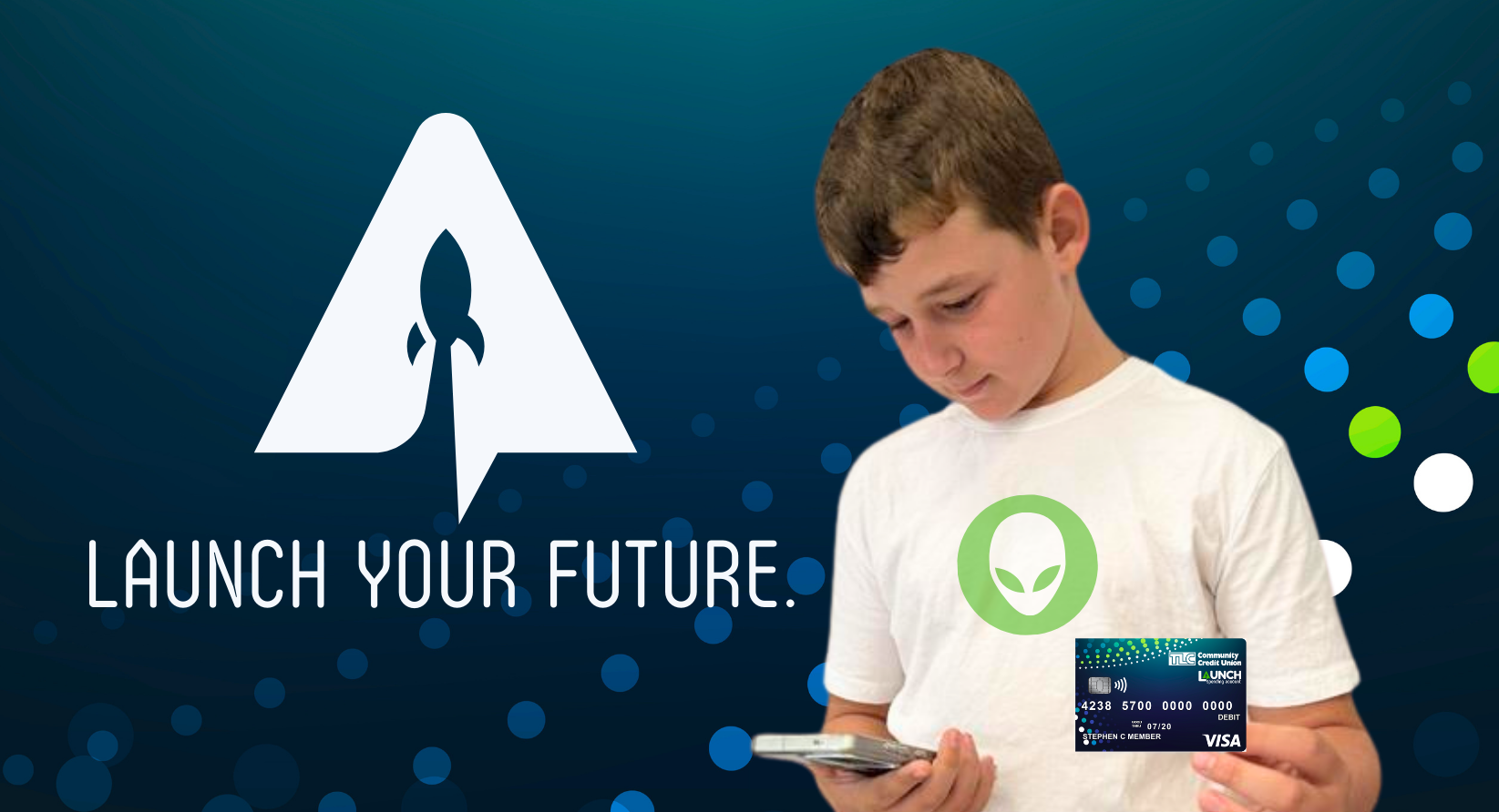 boy holding debit card and looking at phone